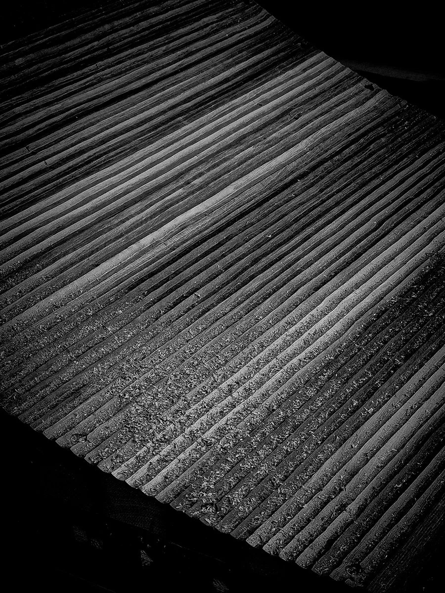 Close-up of the Prehistoric Table's hand-routed freeform textured base in ebonised Jarrah - Nathan Day Design