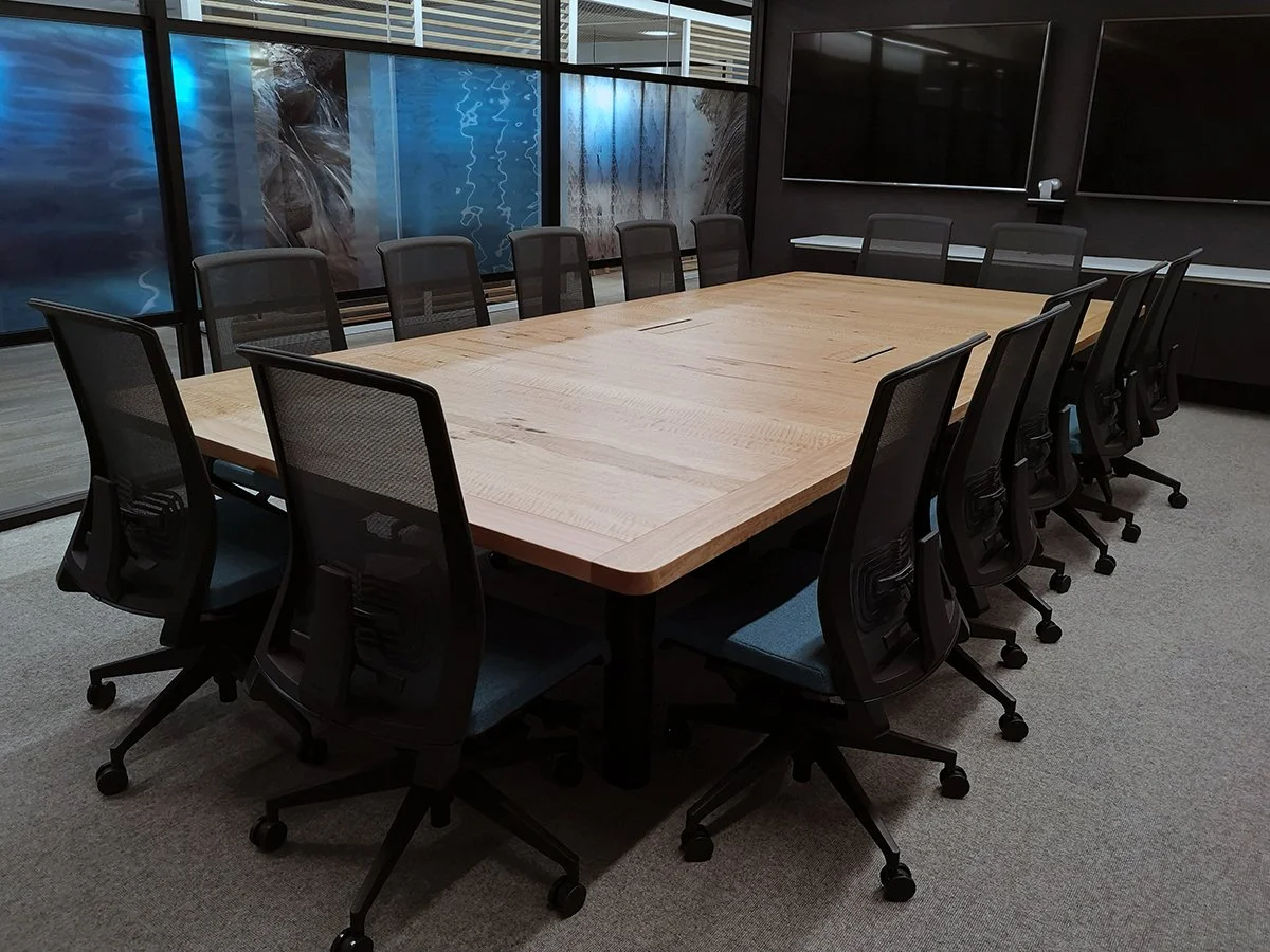 DWER custom furniture in WA Blackbutt - Nathan Day Design, boardroom table with mesh-back chairs against city-view windows