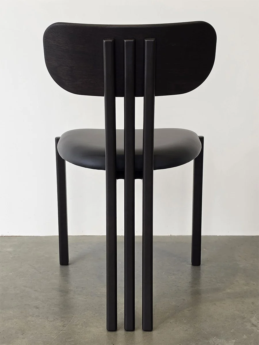 Tulip Chair in ebonised Jarrah with black leather seat, full rear view in plain studio setting - bespoke furniture by Nathan Day Design