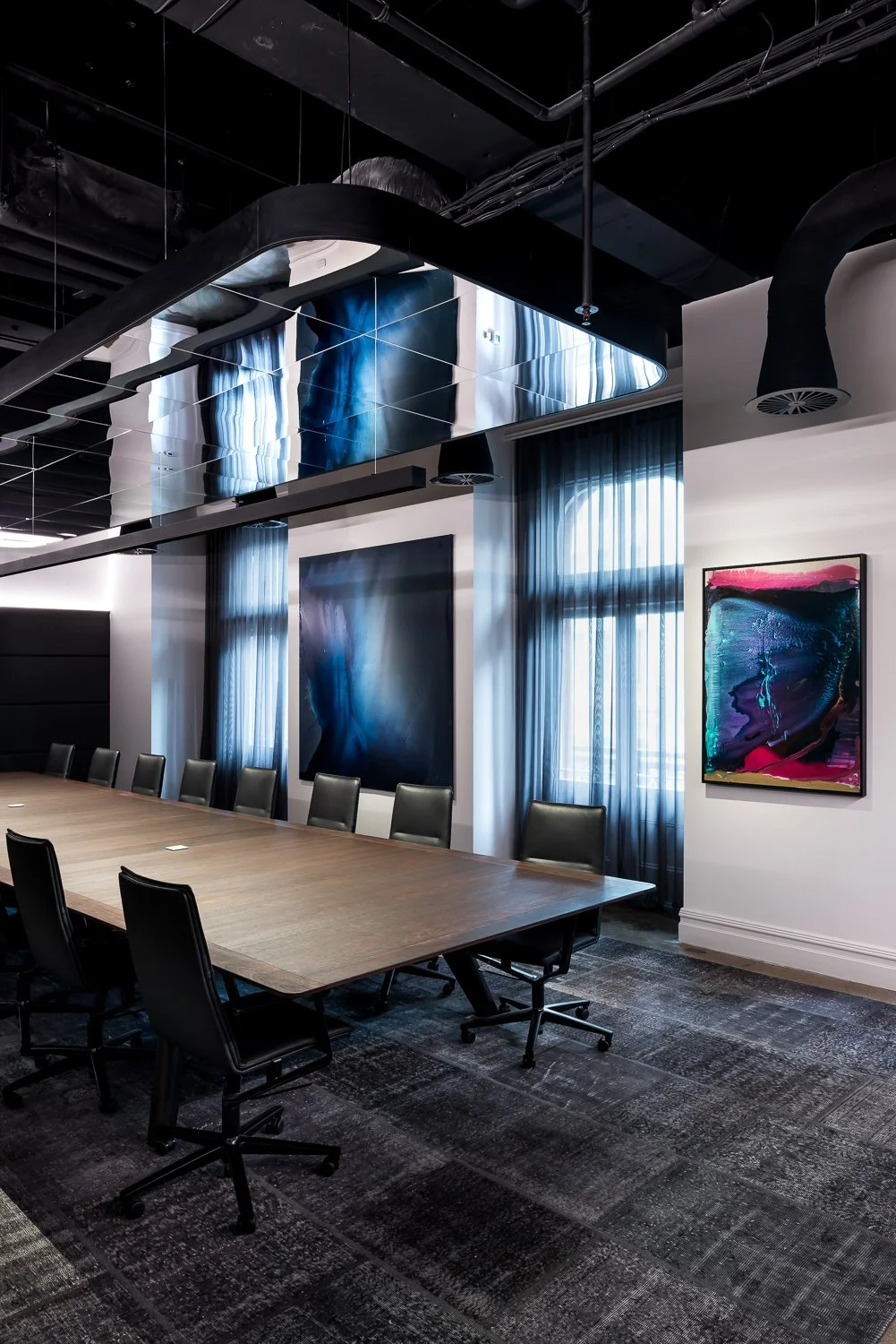 Woods Bagot Boardroom Table in ebonised Jarrah - Nathan Day Design, full boardroom view with artwork and dramatic lighting