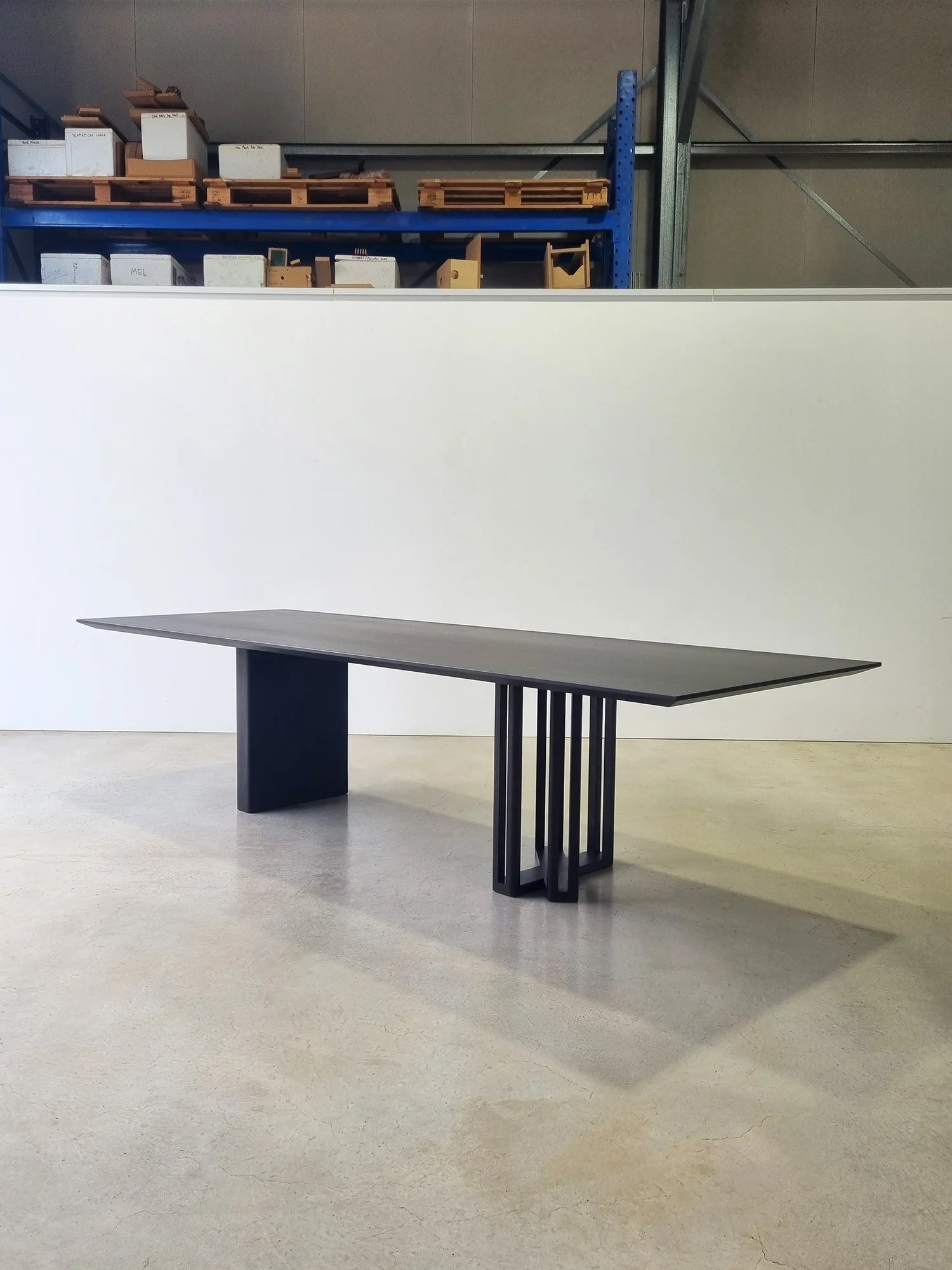 Giacci Table in ebonised Walnut, showing the asymmetrical panel leg and multi-slat leg - bespoke furniture by Nathan Day Design