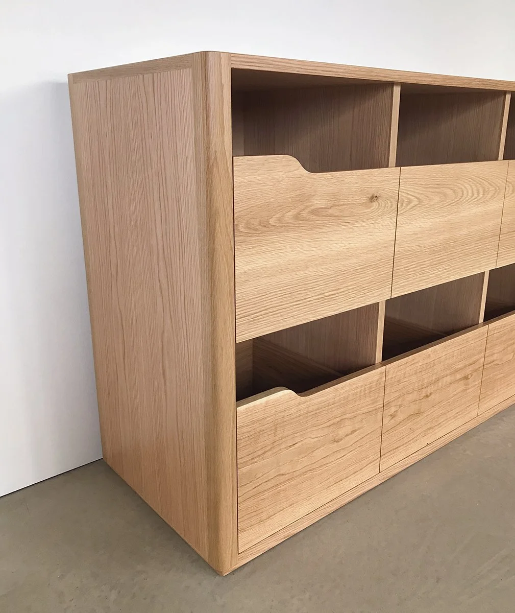 Angwin Record Cabinet in American Oak, angled corner view showing cubby and drawer depth - Nathan Day Design