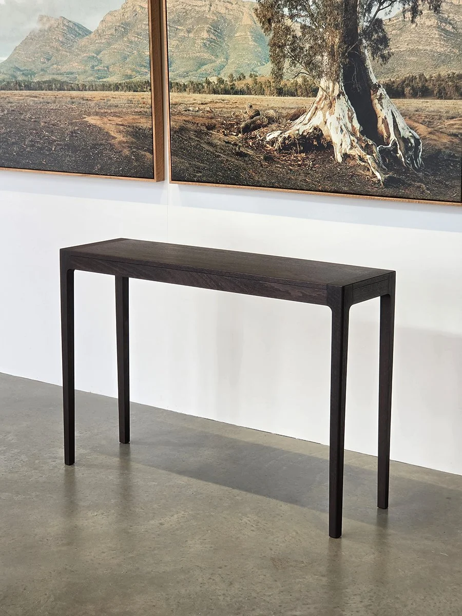 Louis Console in WA Blackbutt, ebonised finish variant, gallery setting with artwork backdrop - Nathan Day Design