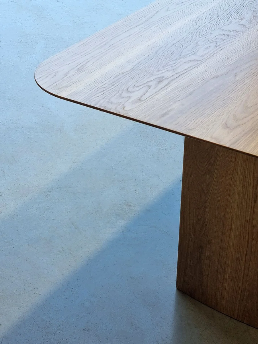 Overhead corner detail of the Southern Ocean Table's rounded American Oak top in natural light - Nathan Day Design