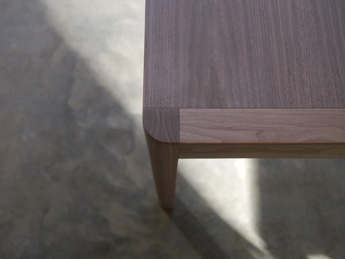 Irvine Desk in Walnut, minimalist frame-leg design - Nathan Day Design, close-up top corner and leg joinery in sunlight
