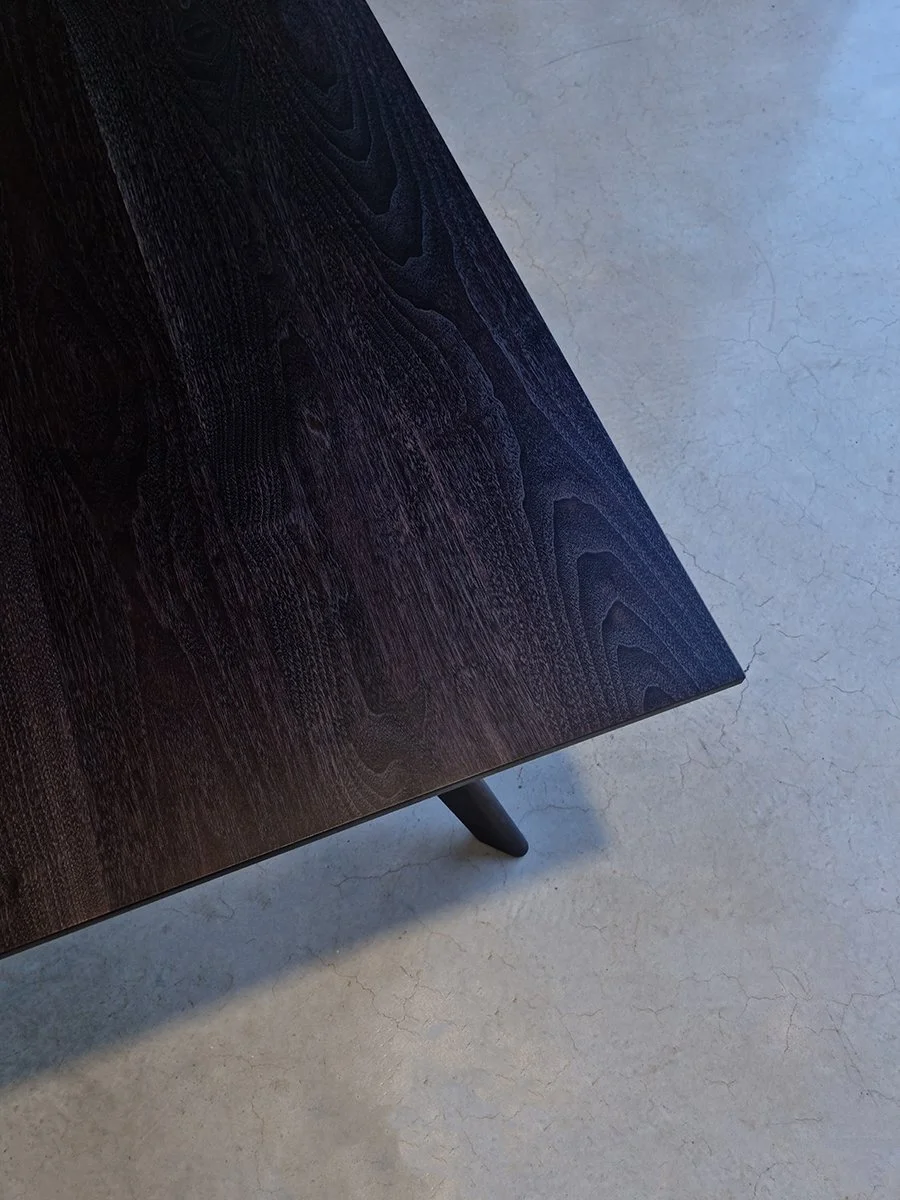 Close-up of Vista St Table corner in ebonised Jarrah showing hand-bevelled edge that gives the top an impossibly thin, floating appearance - bespoke furniture by Nathan Day Design