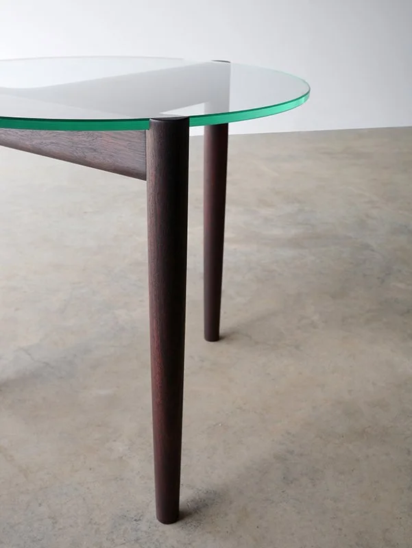 Detail of the 3.2.1 Coffee Table's dark timber legs meeting the glass tabletop edge - Nathan Day Design