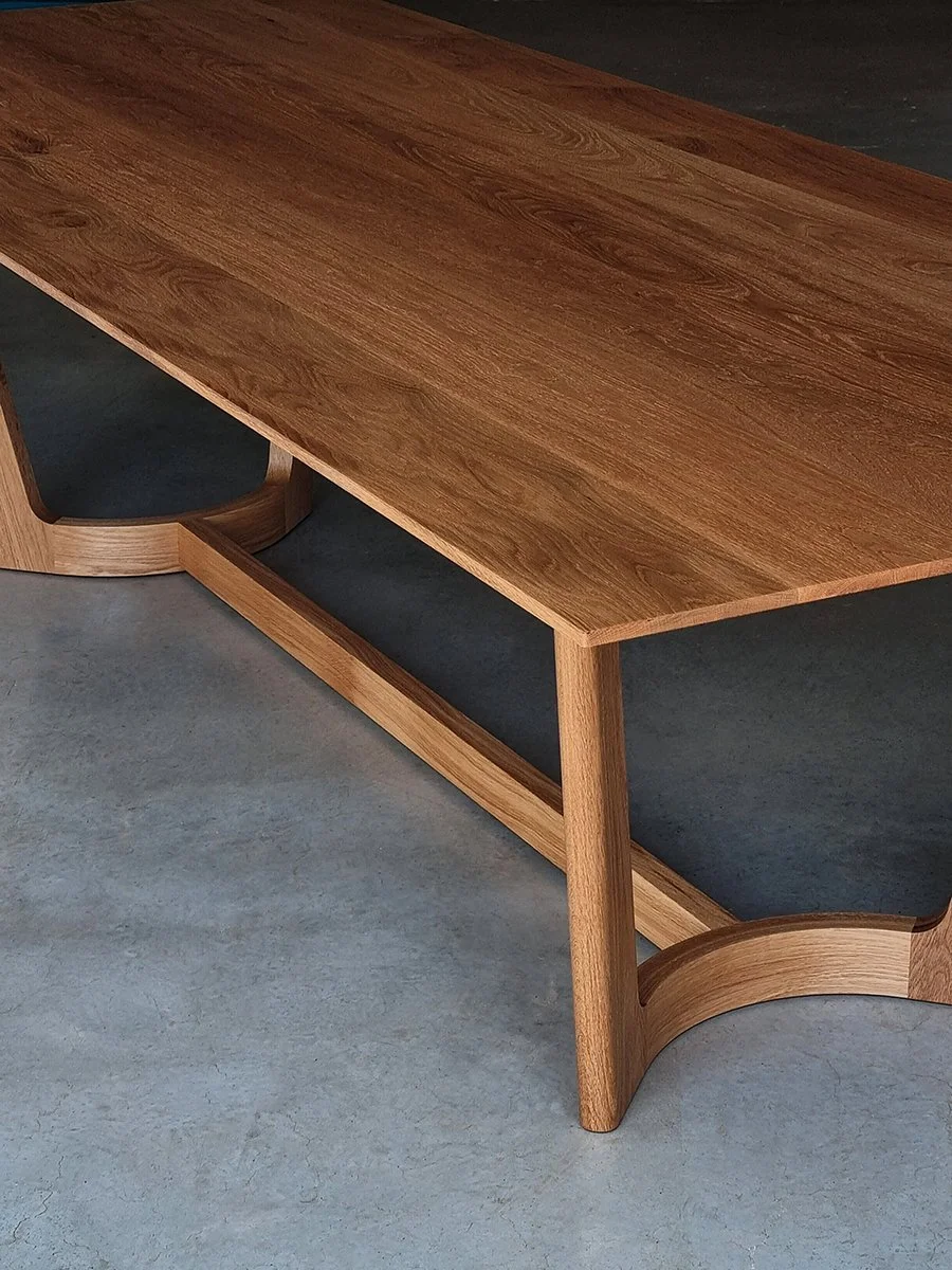 Angled detail of the Froxfield Table in French Oak, showing the curved rail joinery - Nathan Day Design
