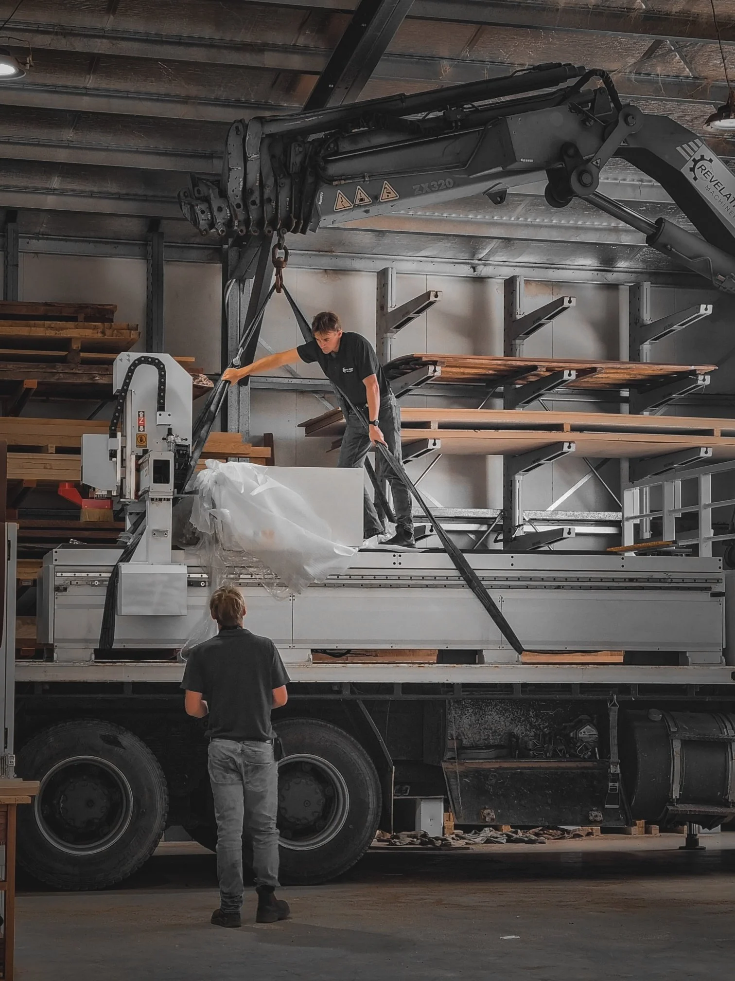 Overhead gantry crane moving large timber stock in the Nathan Day Design workshop
