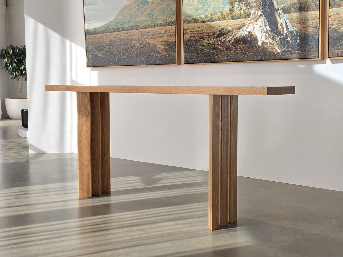 Prism Console in Red Oak, angular prism-shaped leg design, gallery lifestyle setting - Nathan Day Design