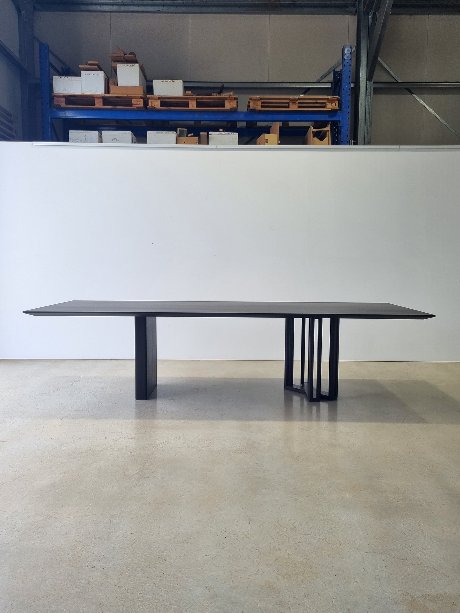 Straight-on front view of the Giacci Table showing its full asymmetrical leg composition - Nathan Day Design