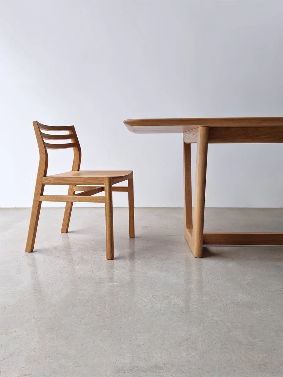 Walter Dining Chair in American Oak with slat back and soft curved seat, paired with a matching Oak dining table - bespoke furniture by Nathan Day Design
