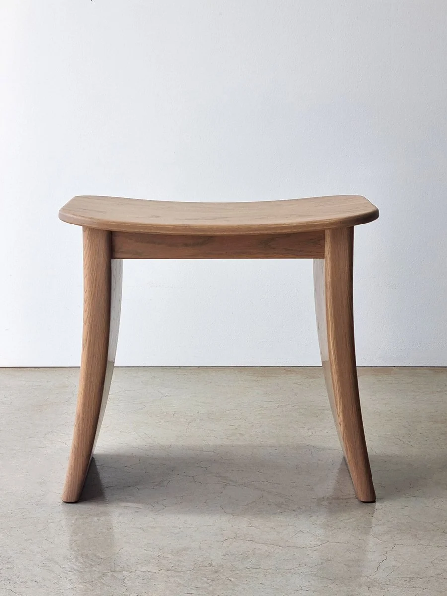 Custom timber stool with curved saddle seat and splayed legs, designed to accompany the Pebble Table - Nathan Day Design