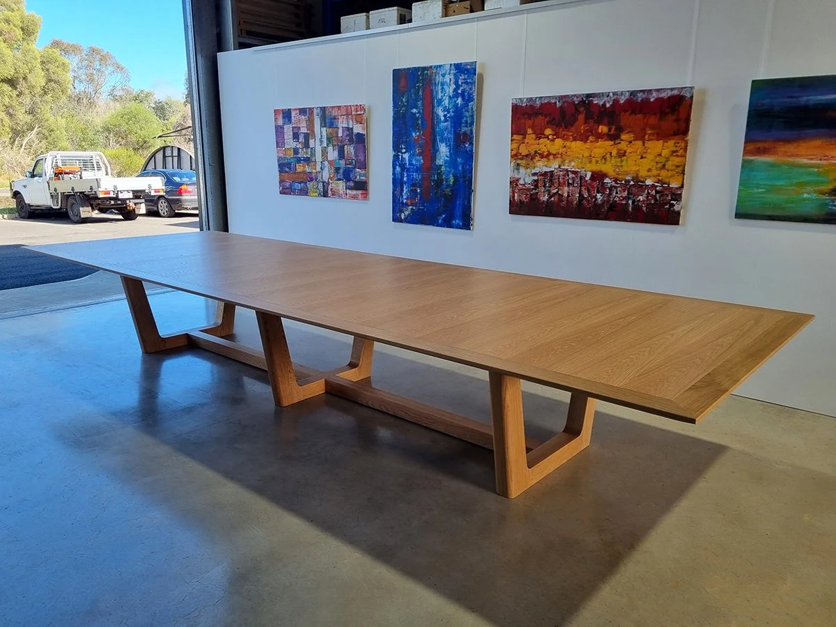 Rhodes House Boardroom Table in American Oak, trestle base design - Nathan Day Design, angled long view showing trestle leg base and grain