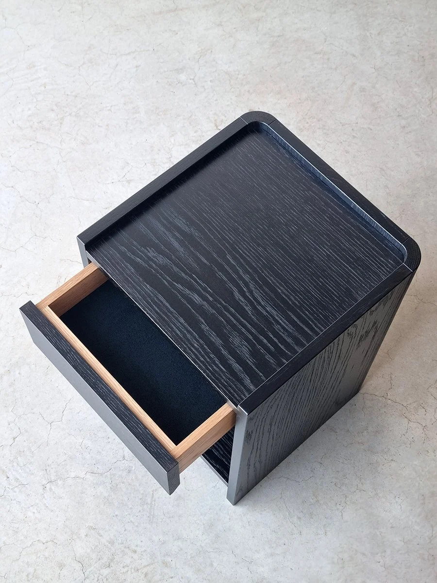 Majestic Close Bedside Table in ebonised Oak - Nathan Day Design, overhead angled view with drawer open showing interior