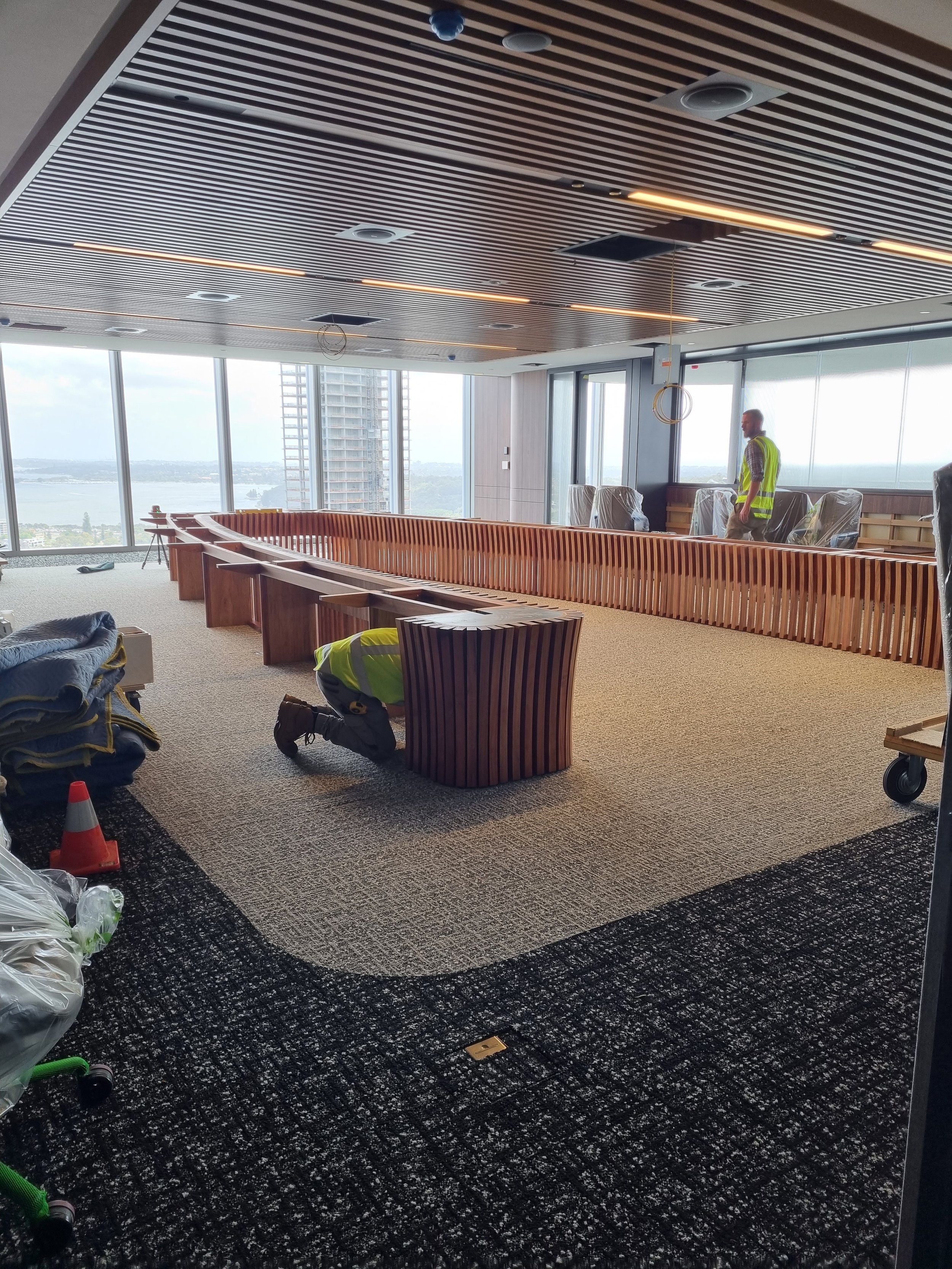 One - The Esplanade Boardroom Table in Australian Blackwood, fluted leg design - Nathan Day Design, table sections being fitted during on-site installation