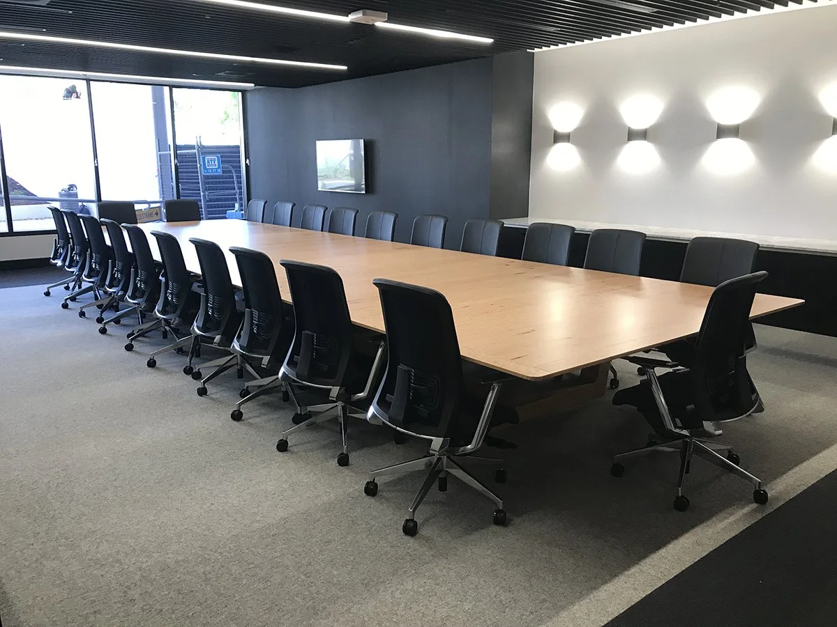 DWER custom furniture in WA Blackbutt - Nathan Day Design, full boardroom with black chairs along accent wall