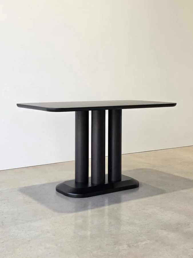 Coop Nook Table in ebonised American Walnut, front view showing three offset legs - bespoke furniture by Nathan Day Design