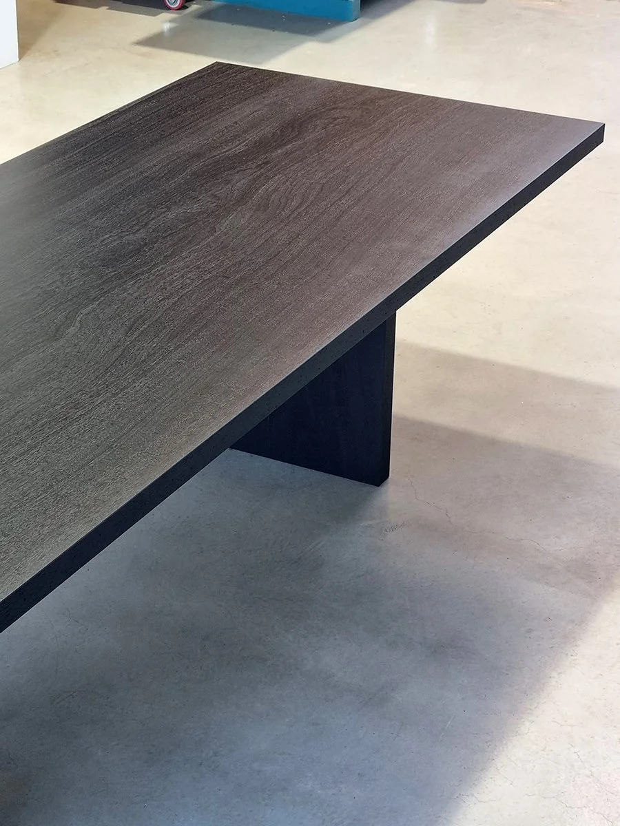 Corner detail of a Como Table section showing the ancient Jarrah grain and flat slab leg - Nathan Day Design