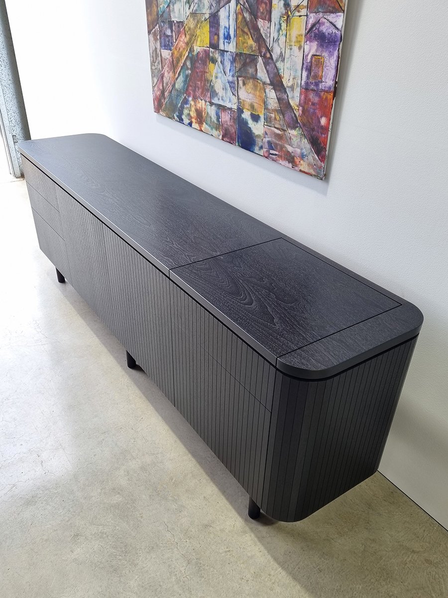 Freeman Loop Credenza in ebonised Walnut, full closed view installed with colourful artwork on wall - Nathan Day Design