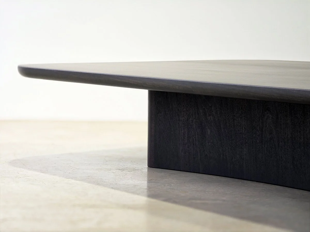 Close-up of the Prehistoric Coffee Table's tabletop edge profile and ebonised jarrah grain - handcrafted bespoke furniture, Nathan Day Design