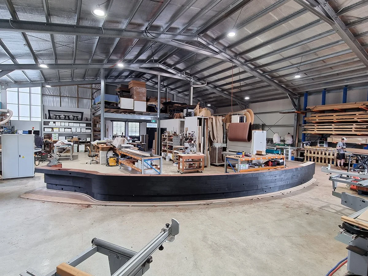 Reception Counter - One The Esplanade in scorched timber - Nathan Day Design, completed curved scorched counter in workshop before delivery