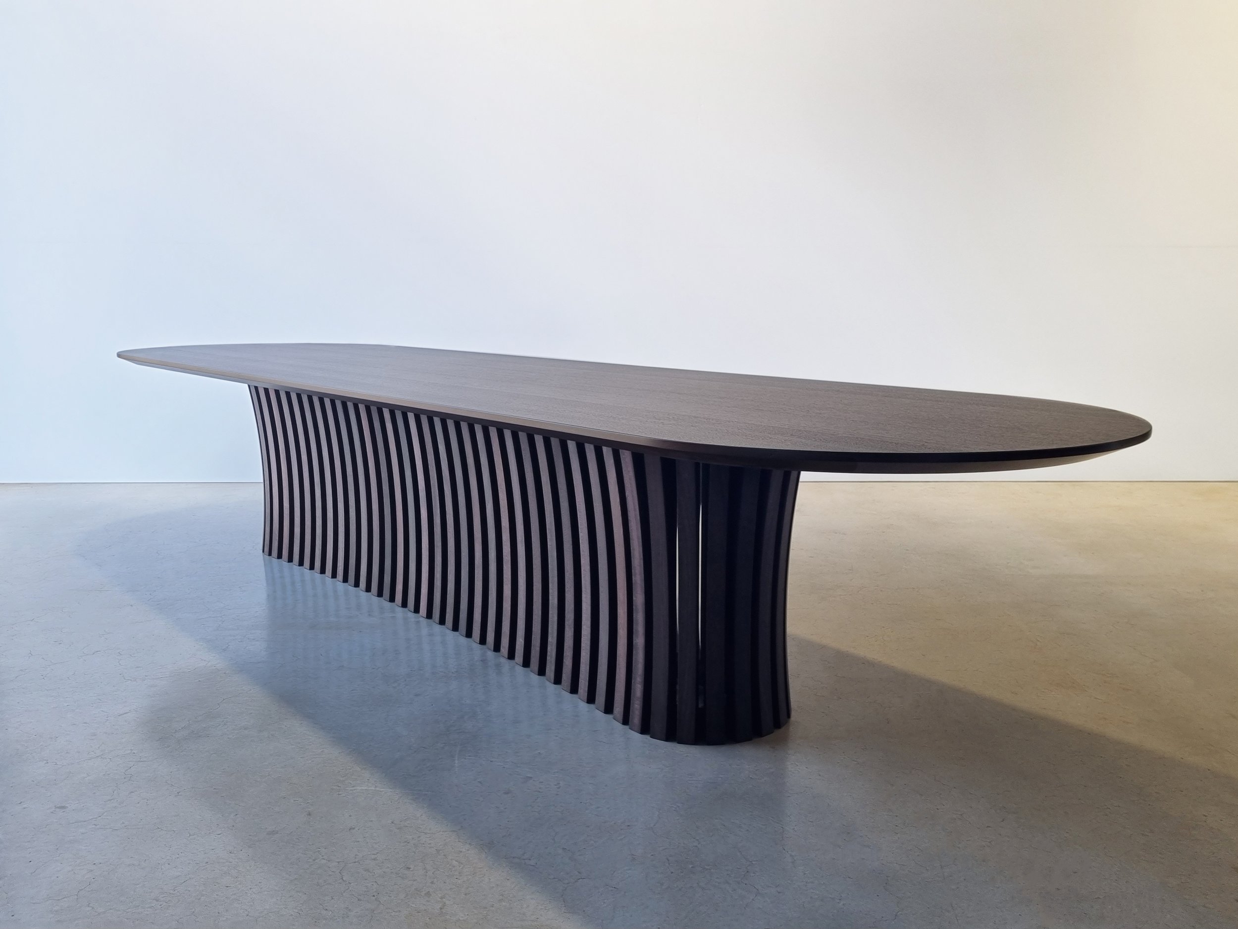 Angled view of the Boundary Lane Table's full fluted pedestal base in ebonised Jarrah - Nathan Day Design
