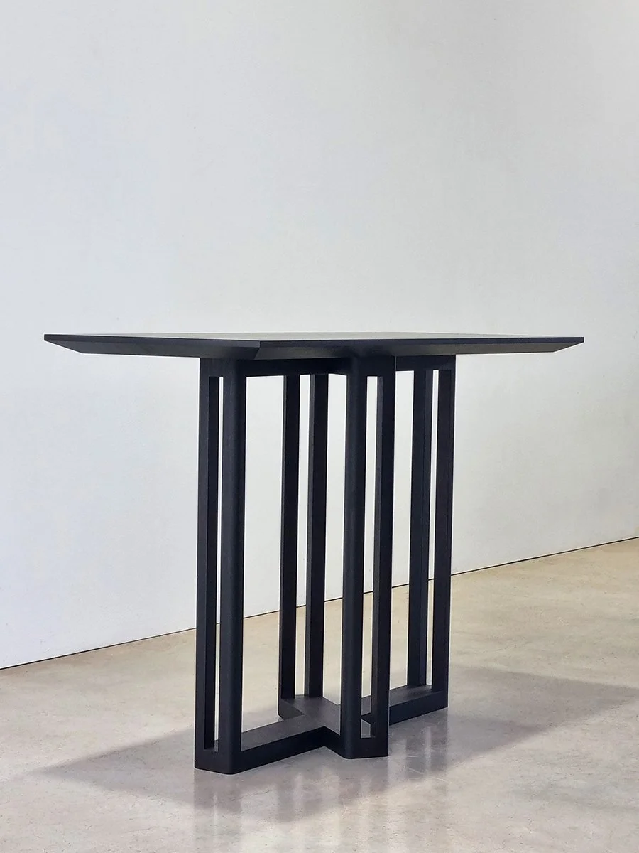 Giacci Console Table in ebonised Jarrah, angled view of vertical slat leg base - Nathan Day Design
