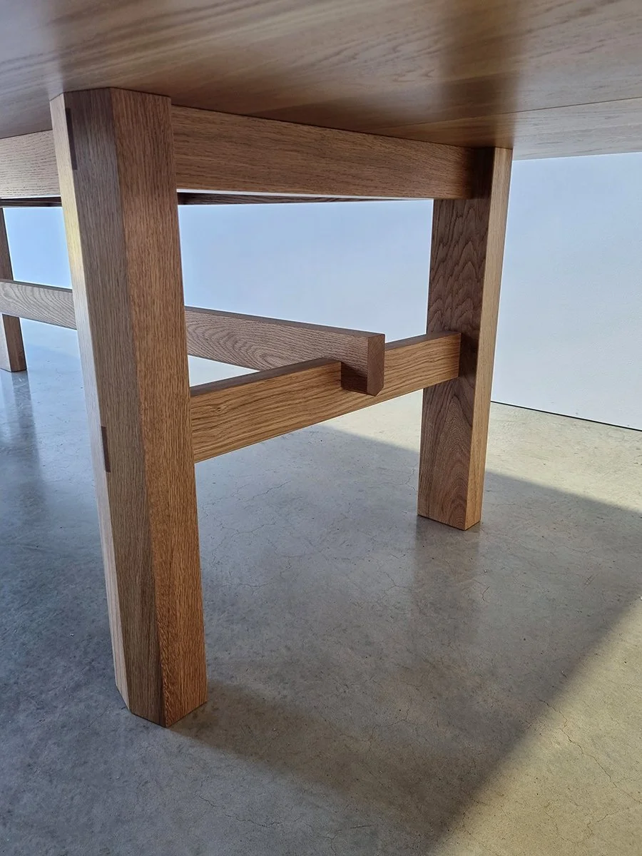 Close-up detail of Laura's Table exposed mortise and tenon joinery in French Oak leg frame - bespoke furniture by Nathan Day Design