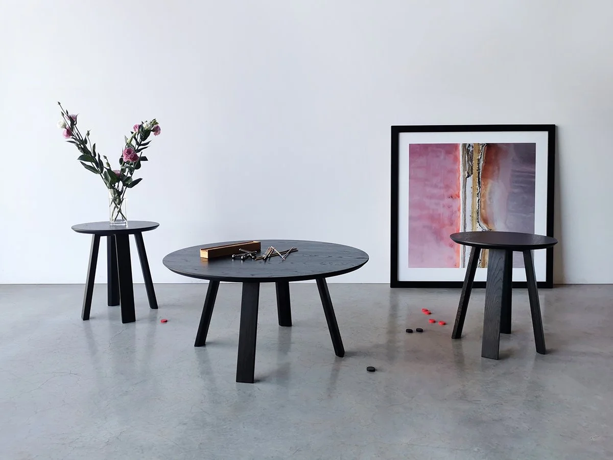 Wonton Stool in blackened Oak shown as low side tables in a styled interior with artwork - Nathan Day Design