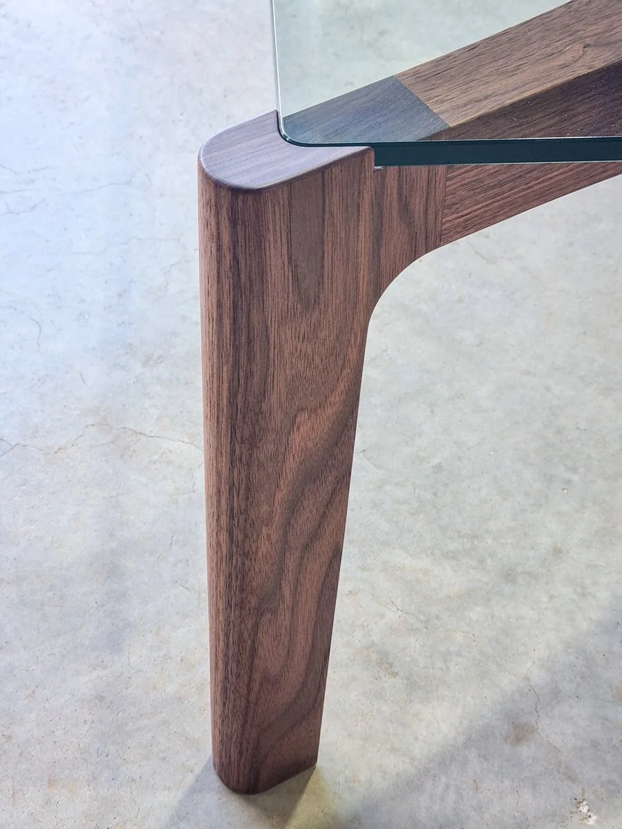 Macro detail of the Wende Coffee Table's rounded American Walnut leg and glass edge - handcrafted by Nathan Day Design