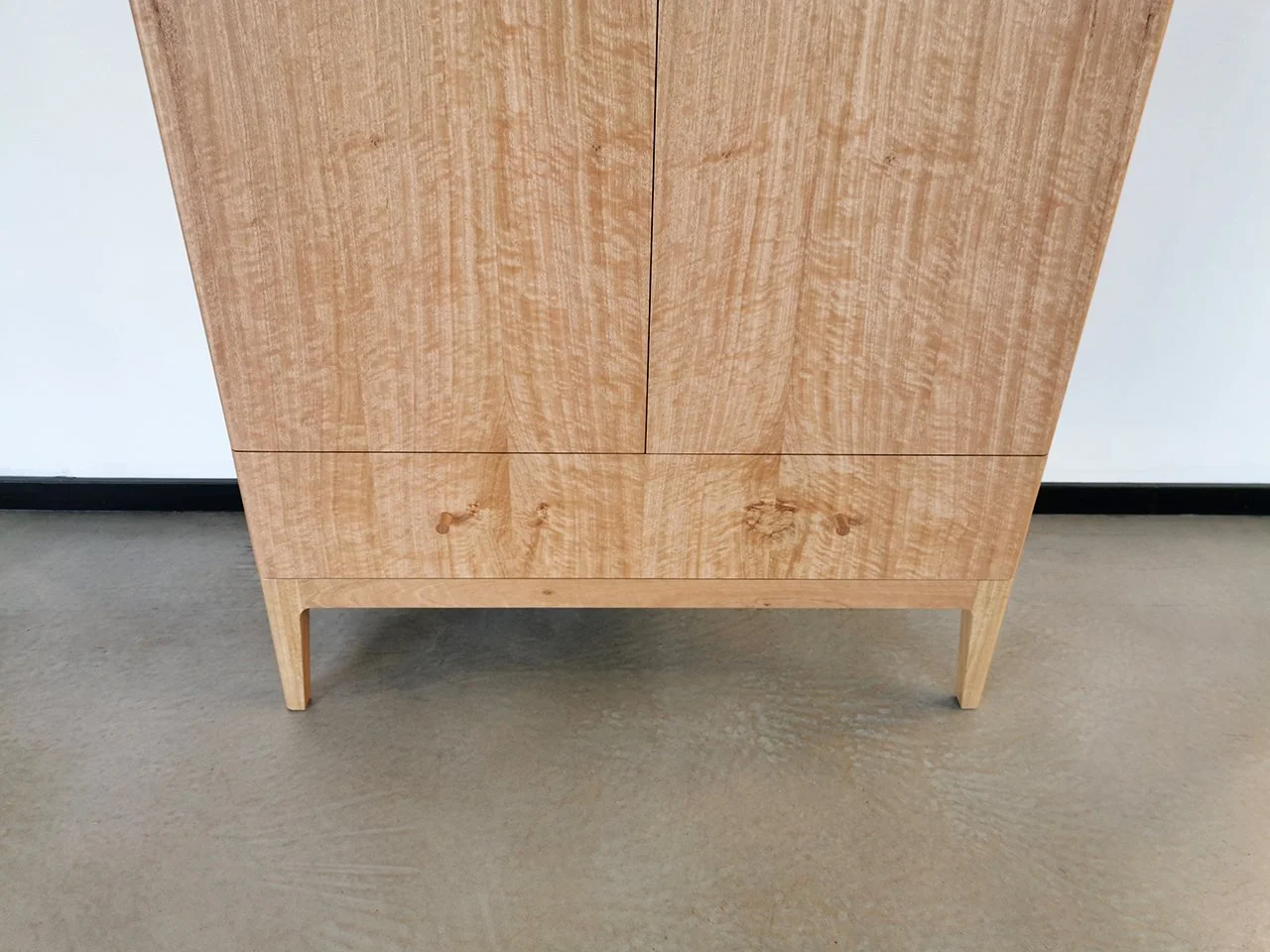 Gifford Rd Cabinet in WA Blackbutt, full front view with closed doors, workshop setting - Nathan Day Design