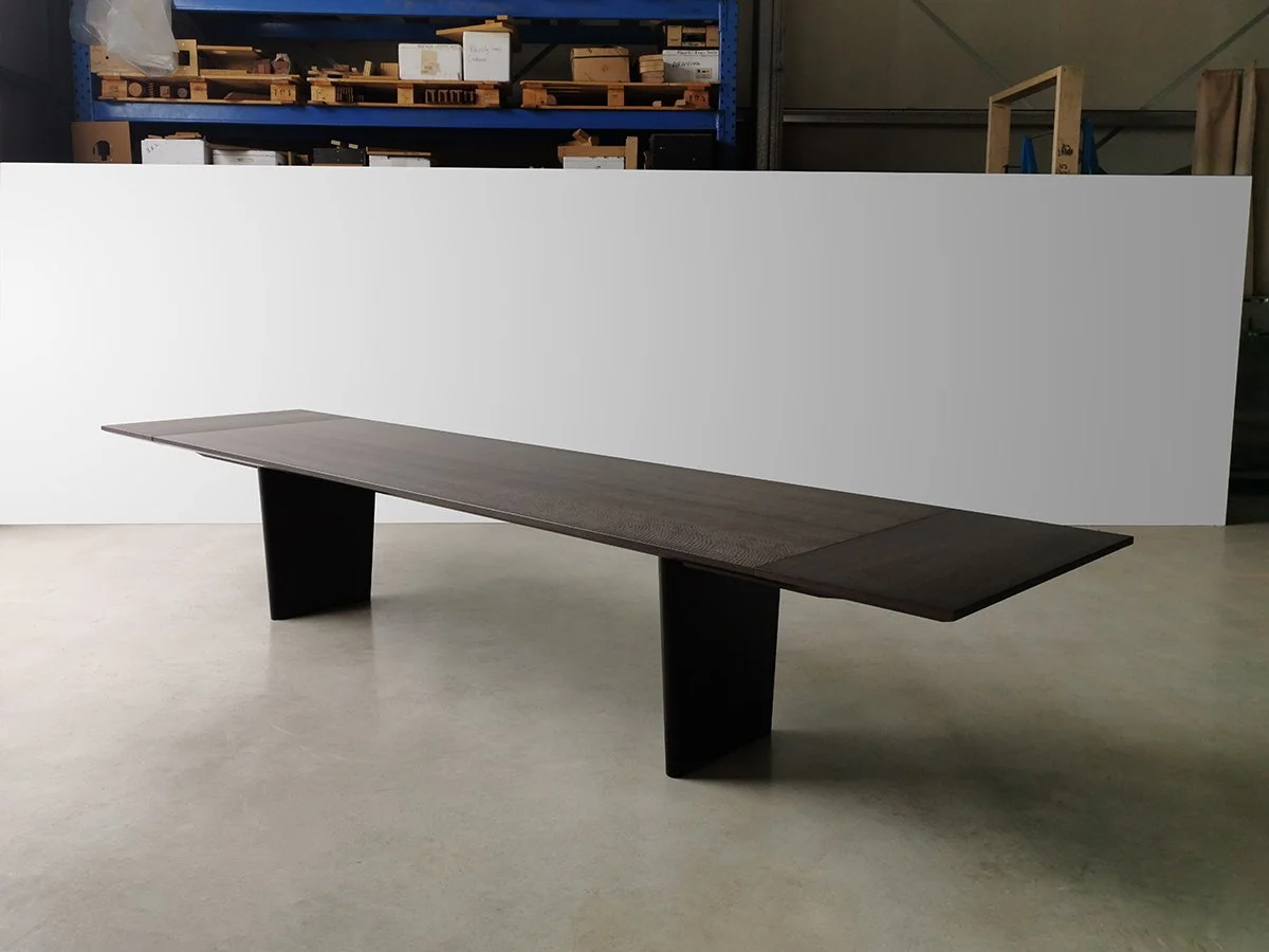 Fully extended Morey Table in ebonised Jarrah in the Nathan Day Design workshop, showing its full extension length