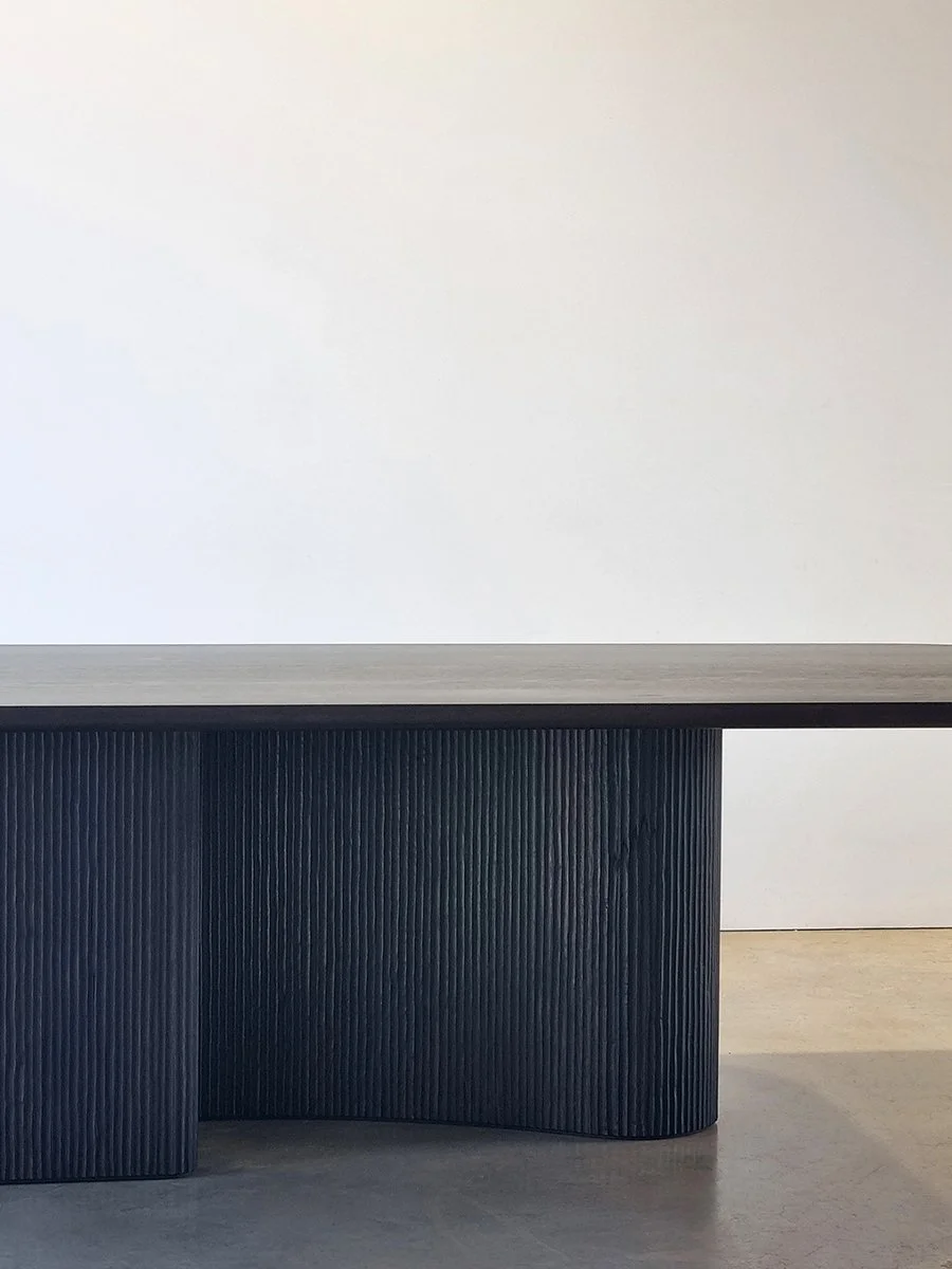 Straight-on view of the Prehistoric Table's sculptural curved base and textured surface - Nathan Day Design