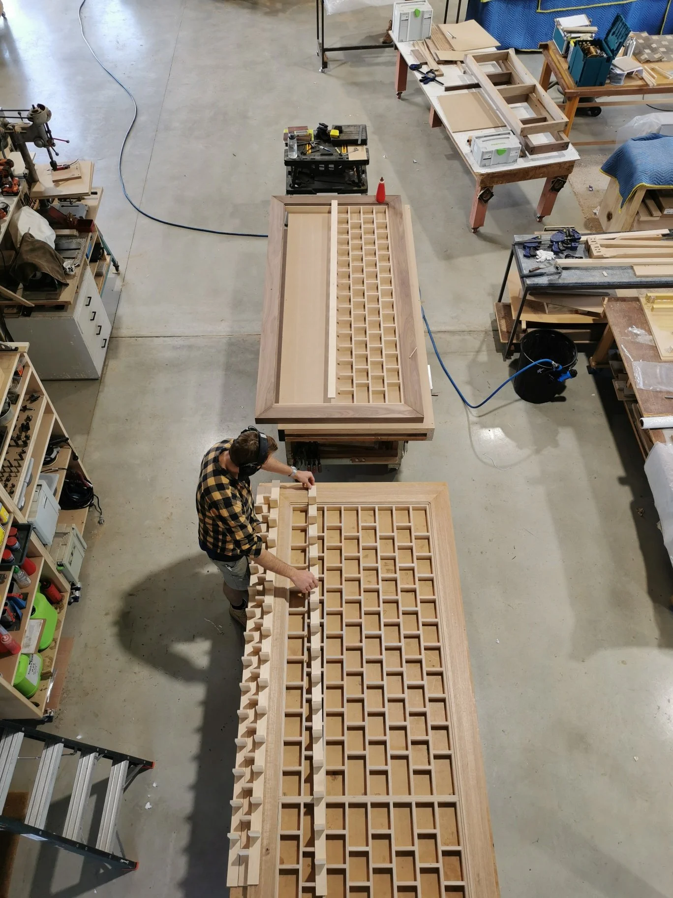 Overhead view of a fluted timber piece being hand-assembled on the workshop floor at Nathan Day Design