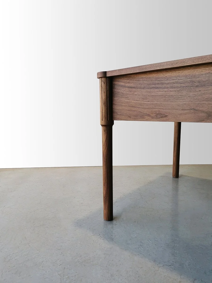 Ventnor Ave Desk in American Walnut, side-angled close-up of tapered leg - Nathan Day Design