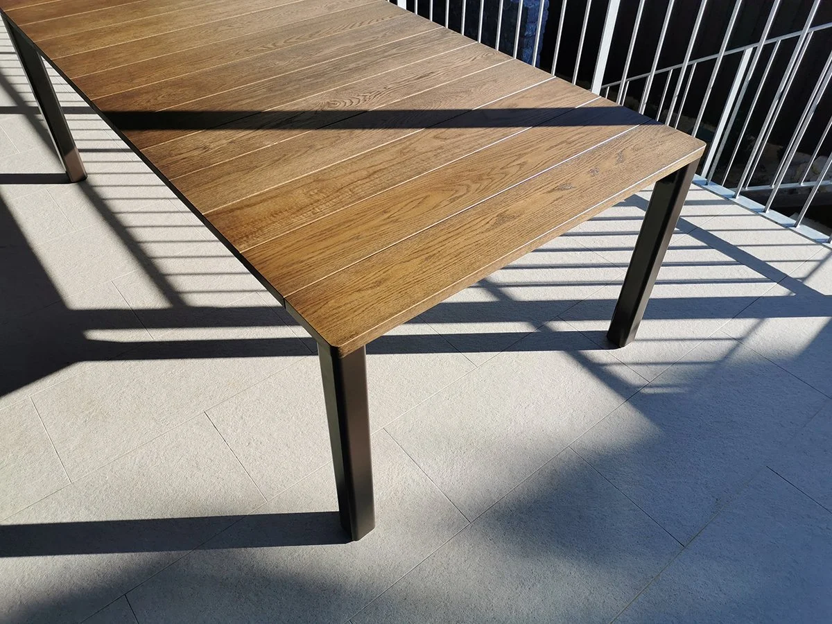 Wardanup Outdoor Table in American Oak - Nathan Day Design, angled close-up of tabletop slats and corner leg
