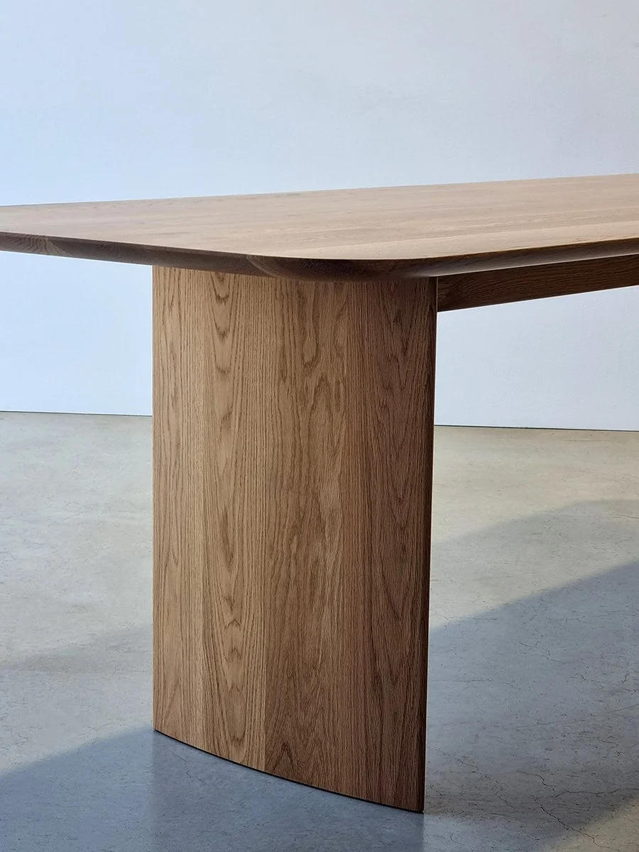 Detail of the Southern Ocean Table's soft curved slab leg edge and American Oak grain - Nathan Day Design