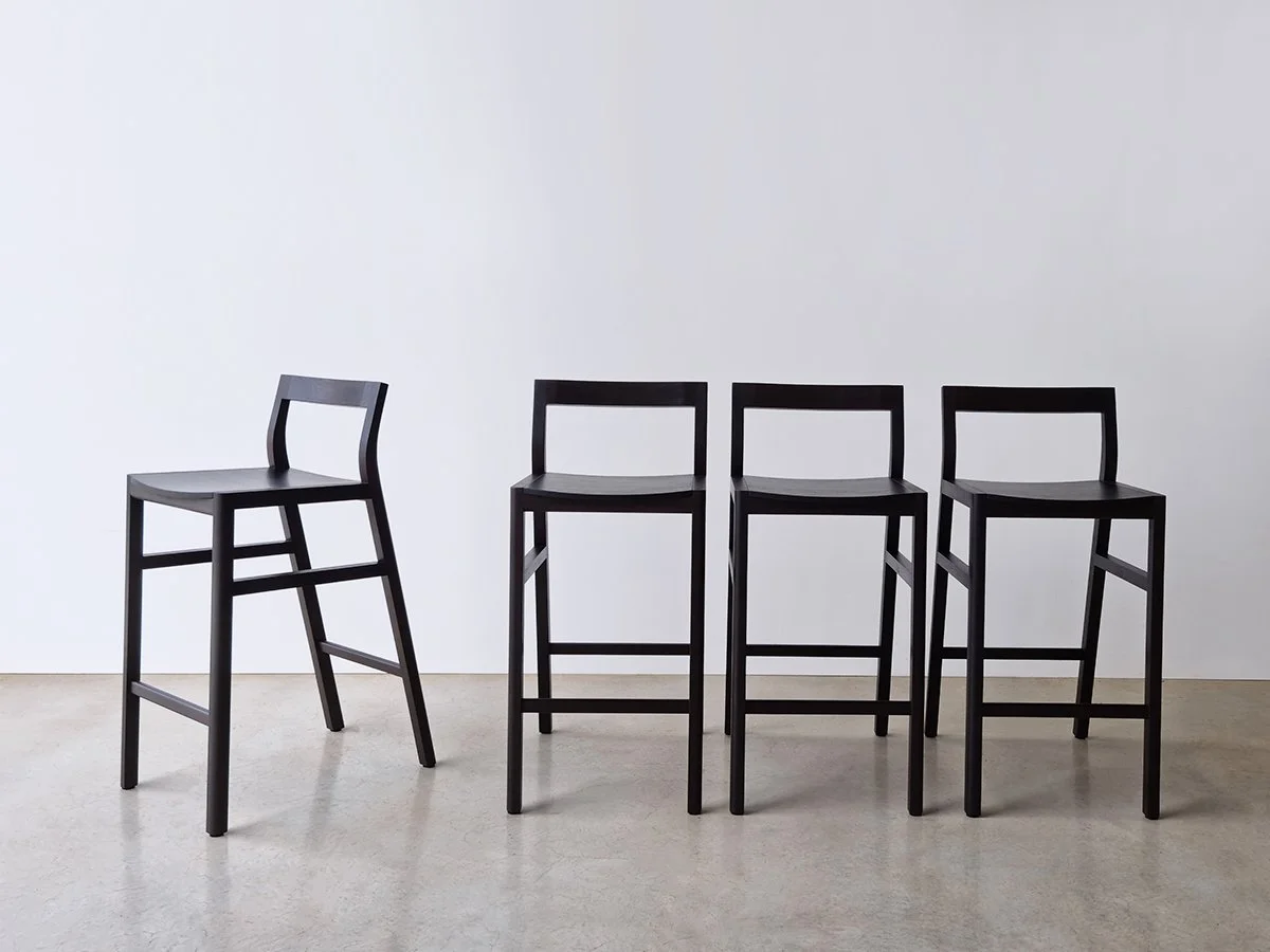Low-back Bar Stools in ebonised Jarrah, group of three shown together in plain studio setting - Nathan Day Design