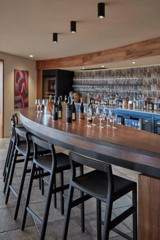 Low-back Bar Stool in ebonised Jarrah, wide view of the fitted bar counter installation - Nathan Day Design