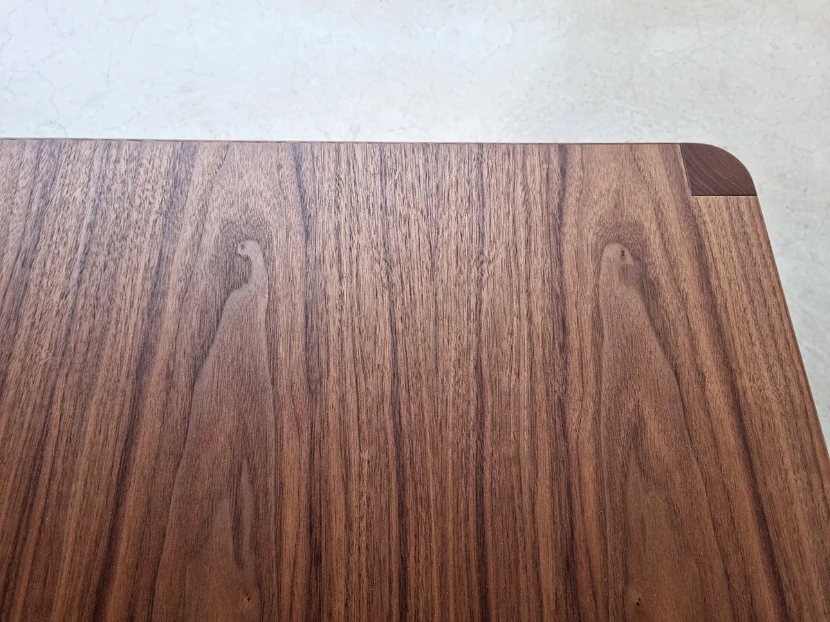 Close-up of the American Walnut grain and mitred corner on the Irvine Coffee Table's top - Nathan Day Design