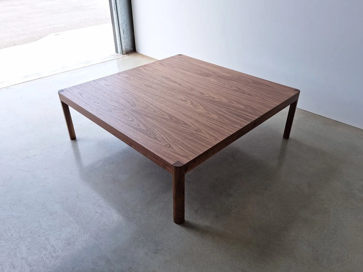 Irvine Coffee Table in American Walnut, square design in a naturally lit studio - bespoke furniture by Nathan Day Design