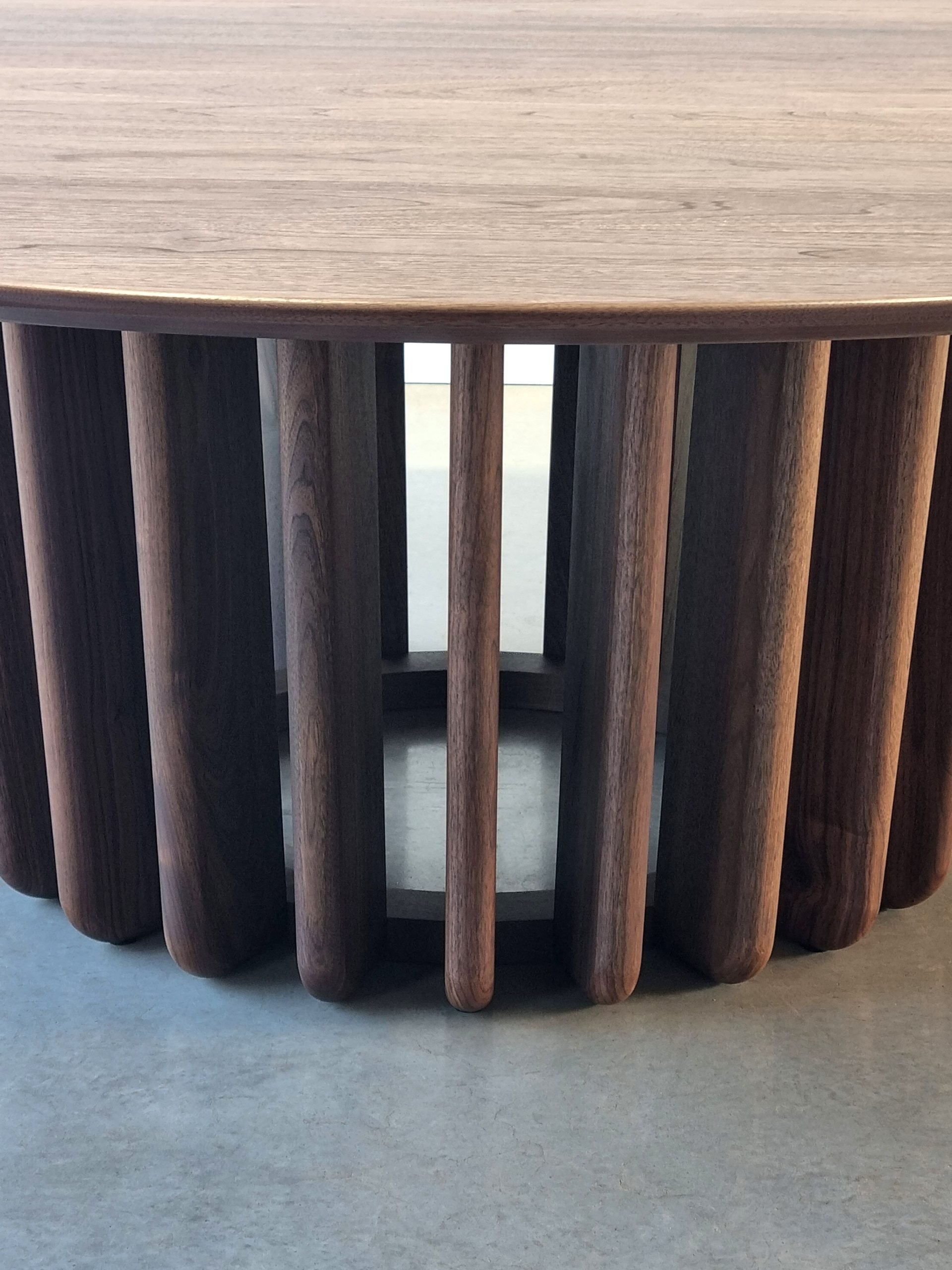Detail through the Lantern Table's Walnut fins, showing light passing between them as the design intended - Nathan Day Design