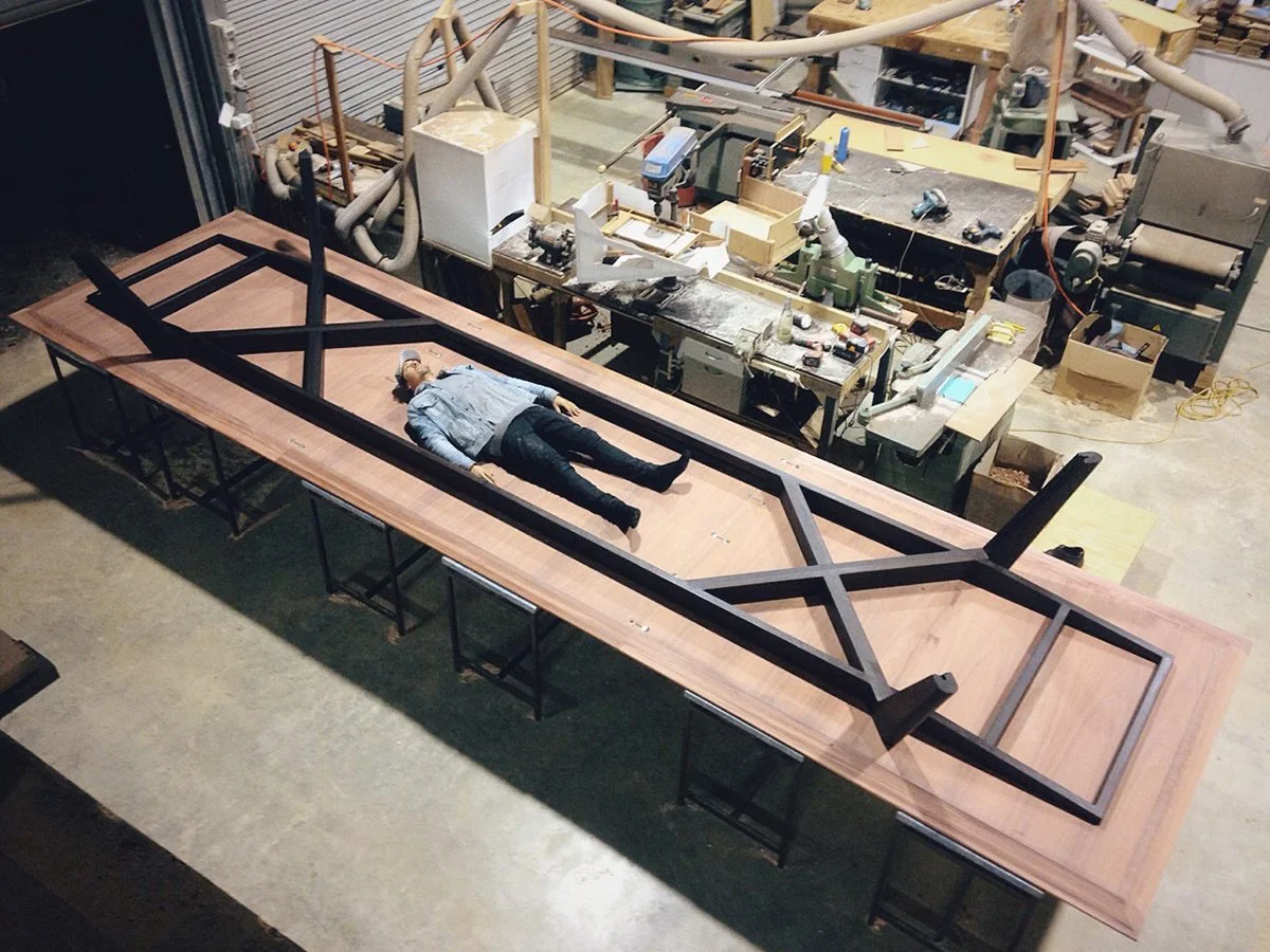 Woods Bagot Boardroom Table in ebonised Jarrah - Nathan Day Design, overhead workshop shot showing steel base frame scale