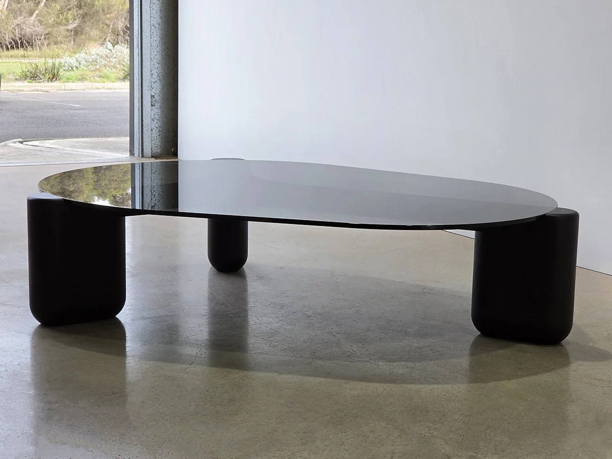 Hippo Coffee Table side profile showing the glass top edge and rounded jarrah legs - bespoke furniture by Nathan Day Design