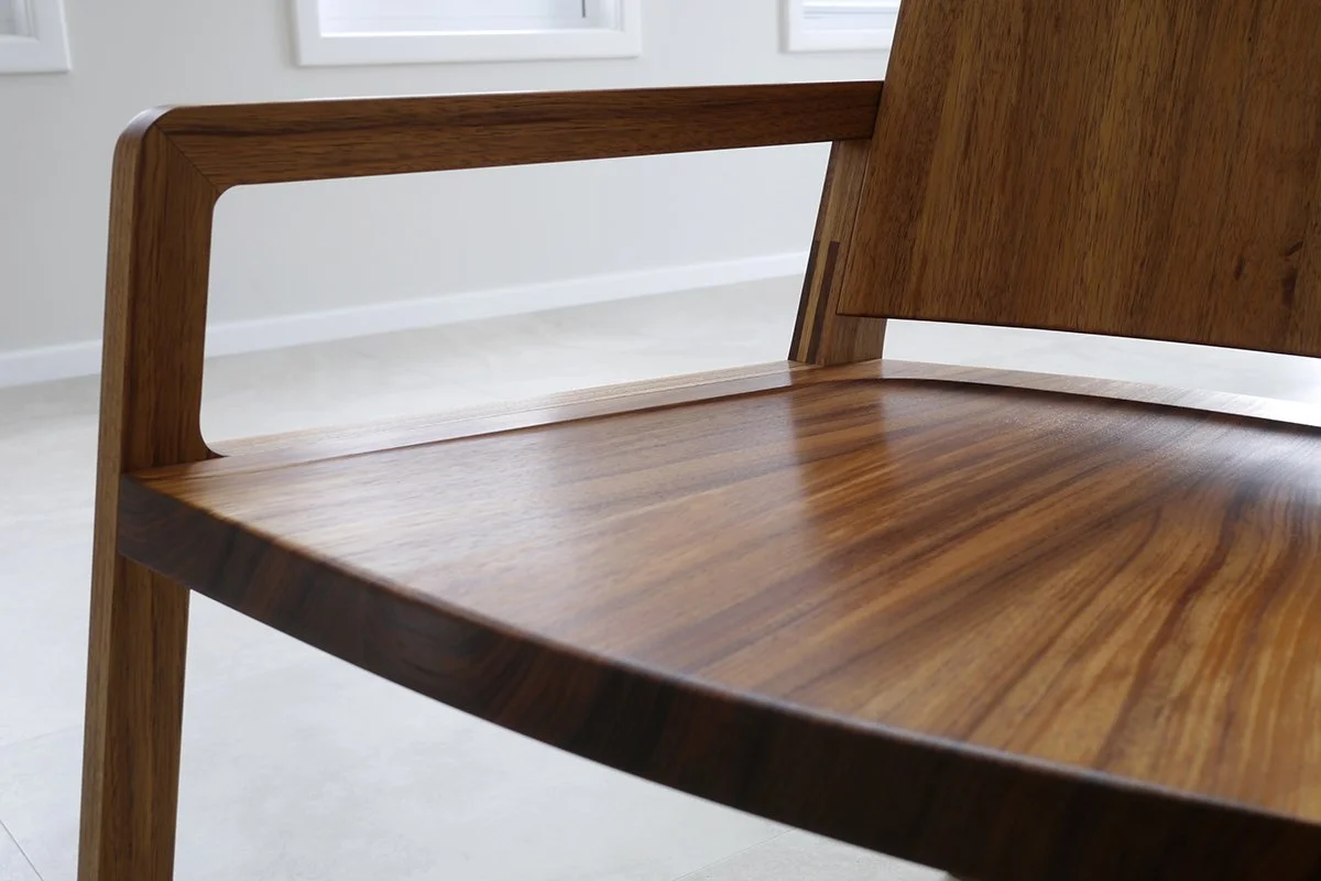 Longitude 131 custom furniture in Tasmanian Blackwood - Nathan Day Design, close-up of bench seat joinery showing curved back rail and grain