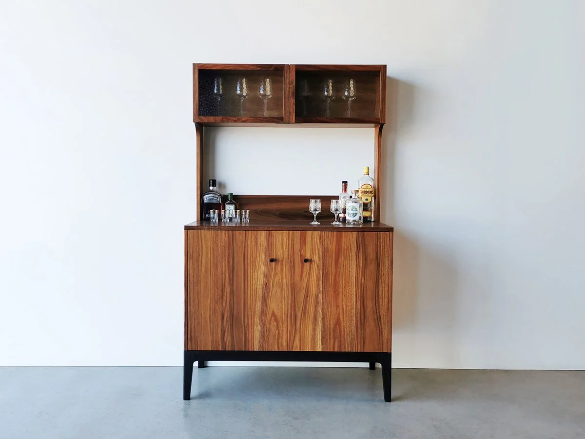Jarvis Drinks Cabinet in Tasmanian Blackwood with ebonised detailing, full front view styled with glassware and bottles - Nathan Day Design
