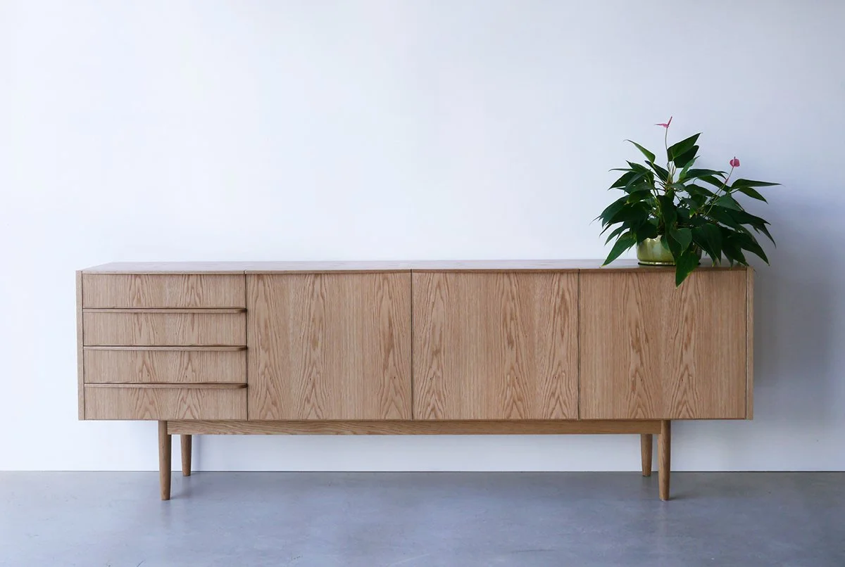 Wembley House Credenza in American Oak, full front view styled with a plant in plain studio setting - Nathan Day Design