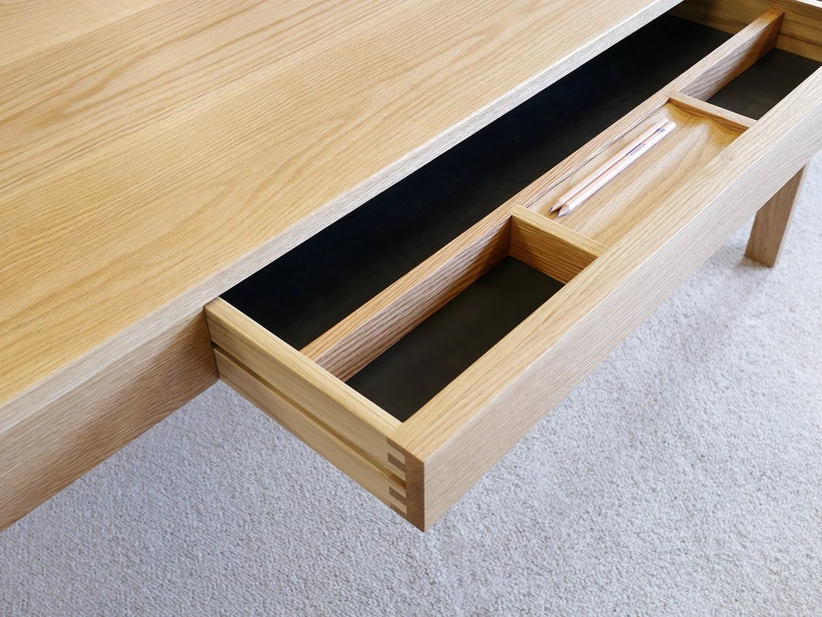 Irvine Desk in Walnut, minimalist frame-leg design - Nathan Day Design, close-up of open drawer in light Oak finish variant