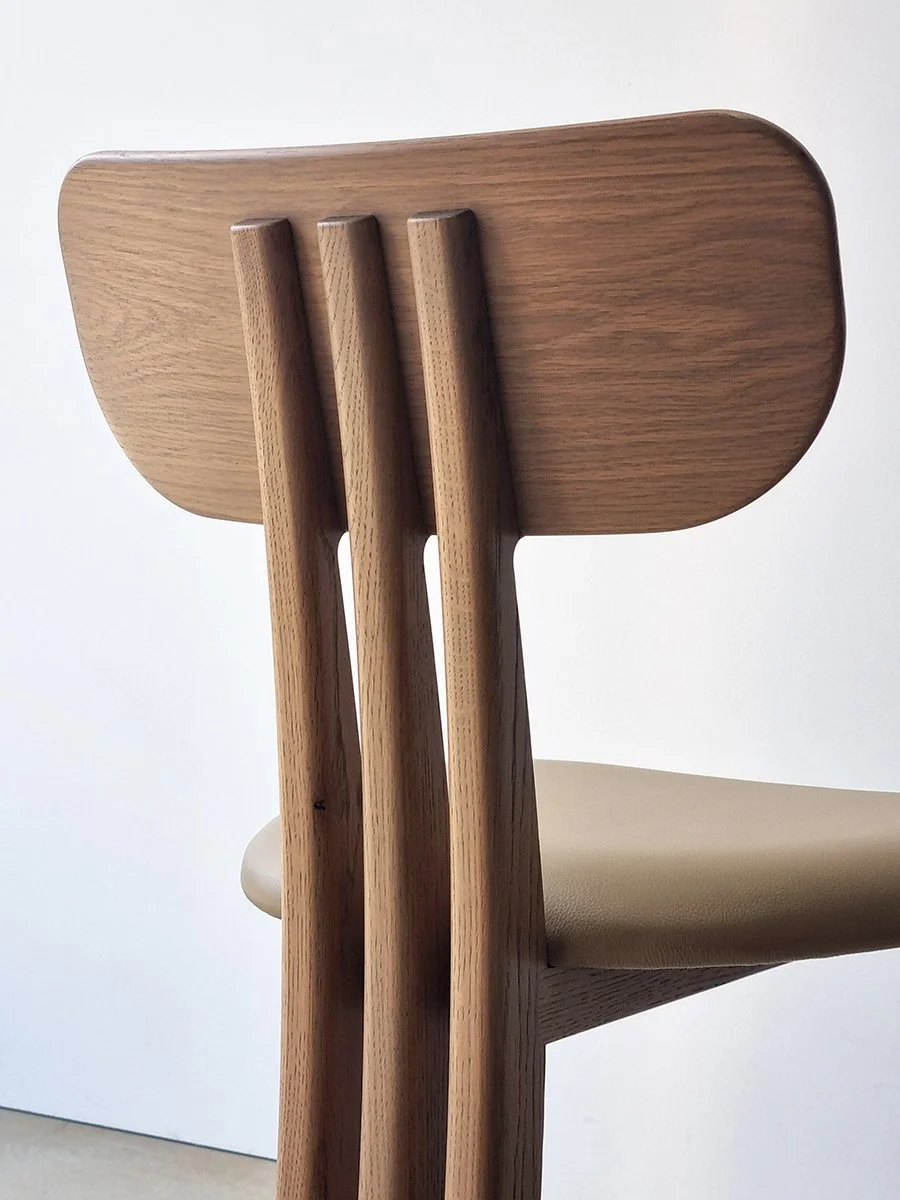 Tulip Chair in American Oak, close-up rear view showing curved backrest and vertical slat construction with tan leather seat - Nathan Day Design bespoke furniture